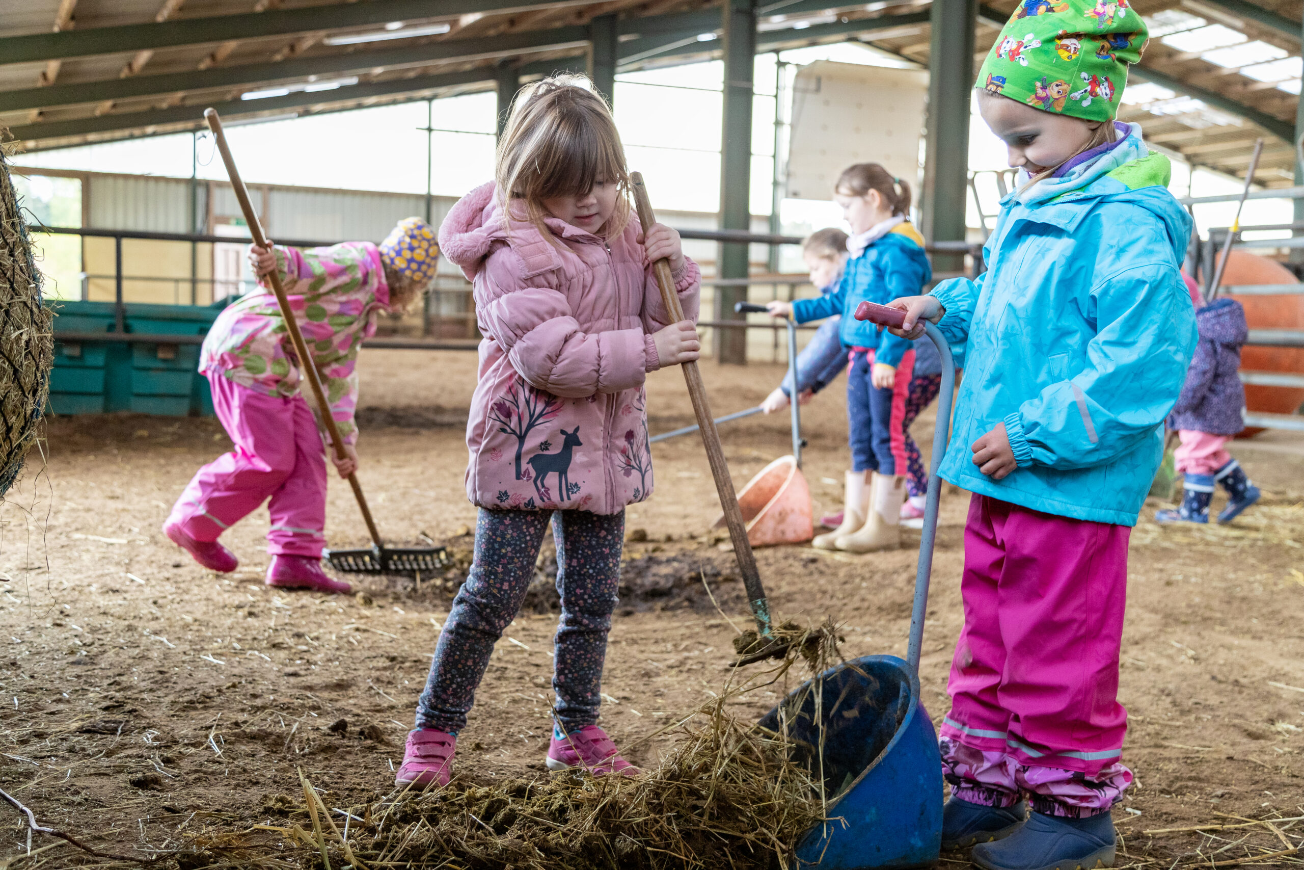 Im bunt dekorierten Kinderbetreuungsraum von Gut Landegge stehen Spielzeug, kleine Möbel, eine Mini-Rutsche und eine Burgkulisse für Kinder bereit.